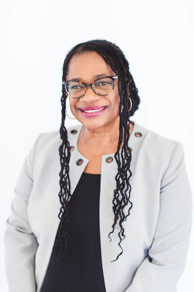 headshot of Sheryl smiling at the camera